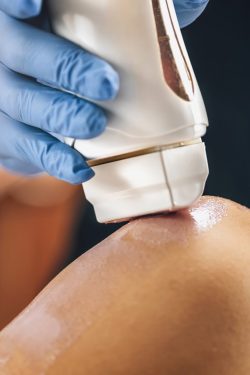 Waxing legs in a beauty salon, wax applicator closeup